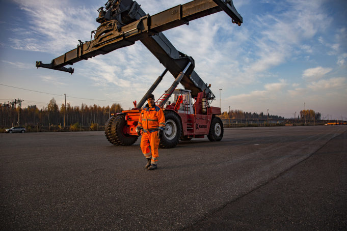 Kouvola RRT oranssipukuinen mies kurottajan kanssa terminaalialueella