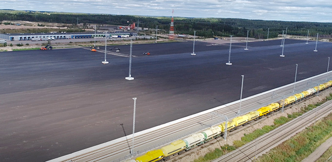 Railway and road terminal from above, loading tracks in the foreground.