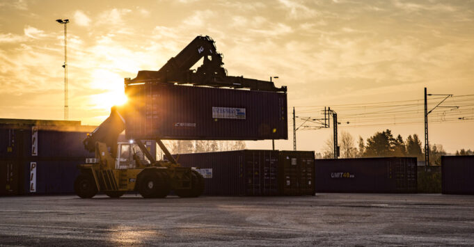 A container crane lifting a cargo container.