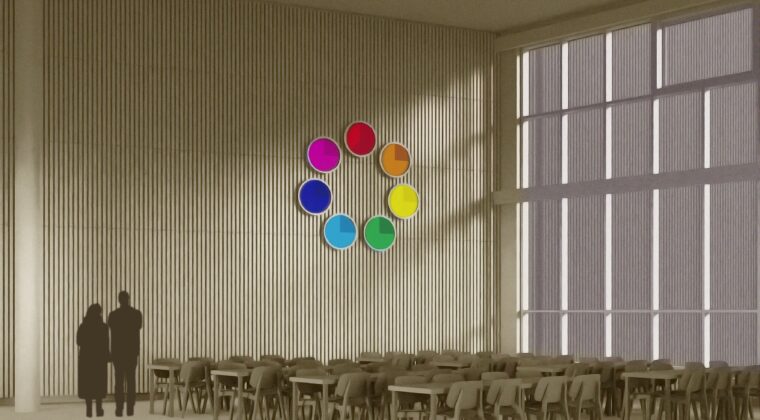Havainnekuva isosta puupintaisesta tilasta, jossa on ruokapöytiä ja tuoleja. Seinällä on seitsemästä pyöreästä näytöstä koostuva väriympyrä. Jokainen ympyrä on eri värinen ja aktivoituu erillisiä näyttöjä koskettamalla.